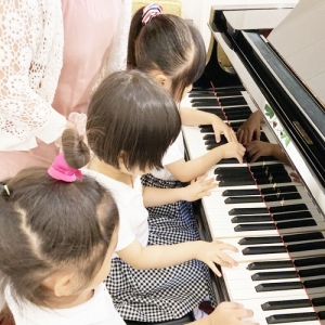 お友だち3人でピアノを弾く生徒たち