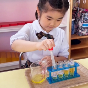 スポイトで液体を別の容器に移す生徒