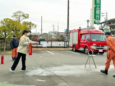 消防士さんに消火器の使い方を教わる先生